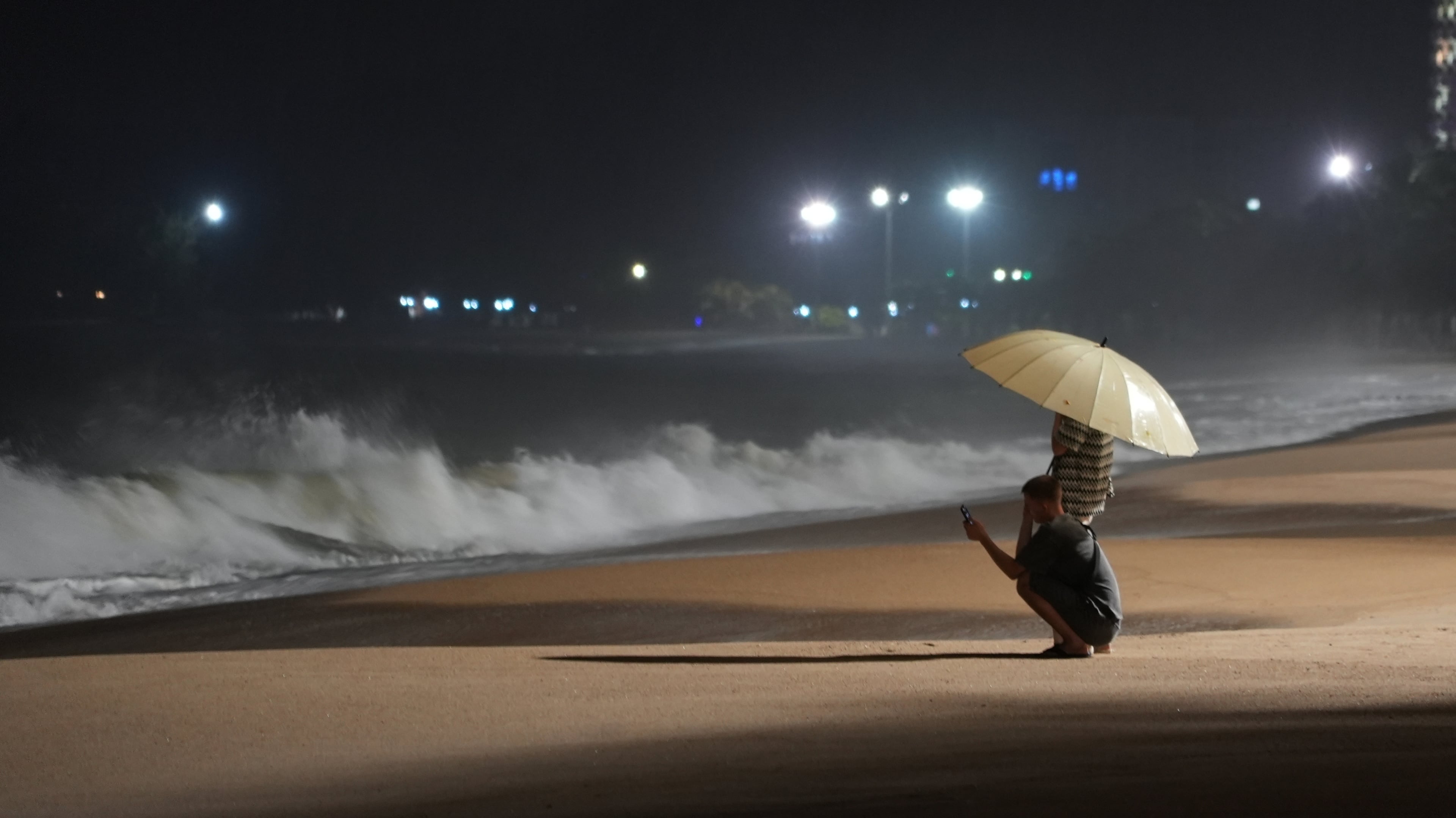 People watch rough waves caused by Typhoon Kalmaegi in Khanh Hoa, Vietnam, Thursday, Nov. 6, 2025. (AP Photo/Hau Dinh)