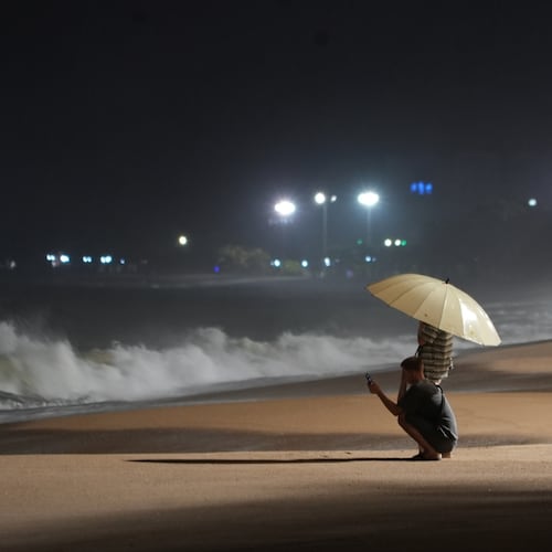 People watch rough waves caused by Typhoon Kalmaegi in Khanh Hoa, Vietnam, Thursday, Nov. 6, 2025. (AP Photo/Hau Dinh)