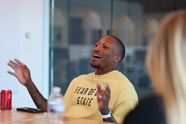 Lecrae leads a devotion at the start of a staff meeting at Reach Records, Monday, June 9, 2025, in Atlanta. Lecrae’s Reach Records has recently celebrated 20 years.  (Jason Getz / AJC)