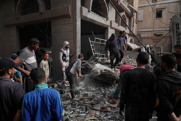 Palestinians inspect the damage caused by an Israeli army airstrike in Khan Younis, Gaza Strip, Tuesday, April 22, 2025. (AP Photo/Abdel Kareem Hana)