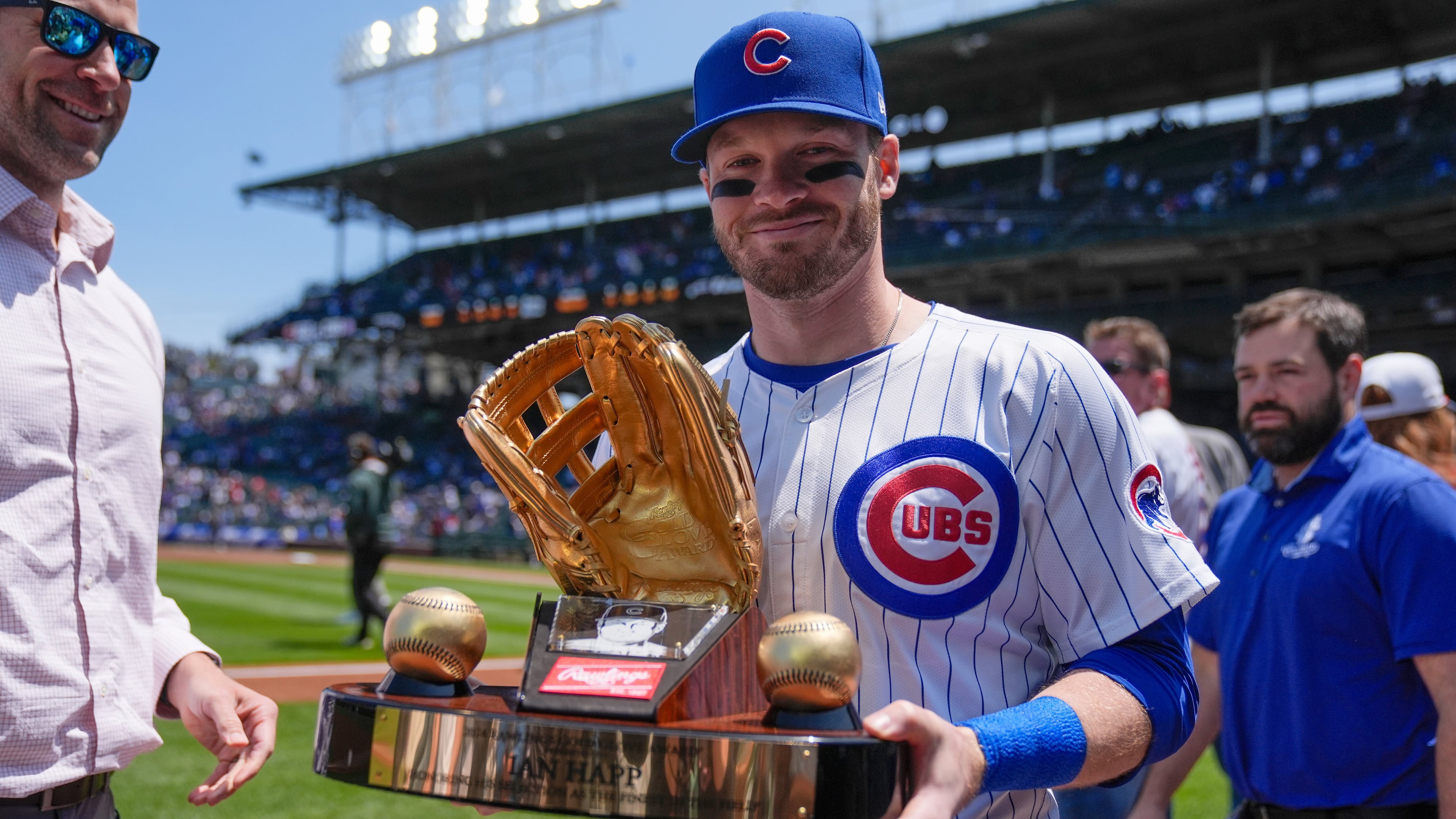 FILE - Chicago Cubs' Ian Happ (8) holds his Gold Glove Award trophy before a baseball game against the Cincinnati Reds, Saturday, May 31, 2025, in Chicago. (AP Photo/Erin Hooley, File)