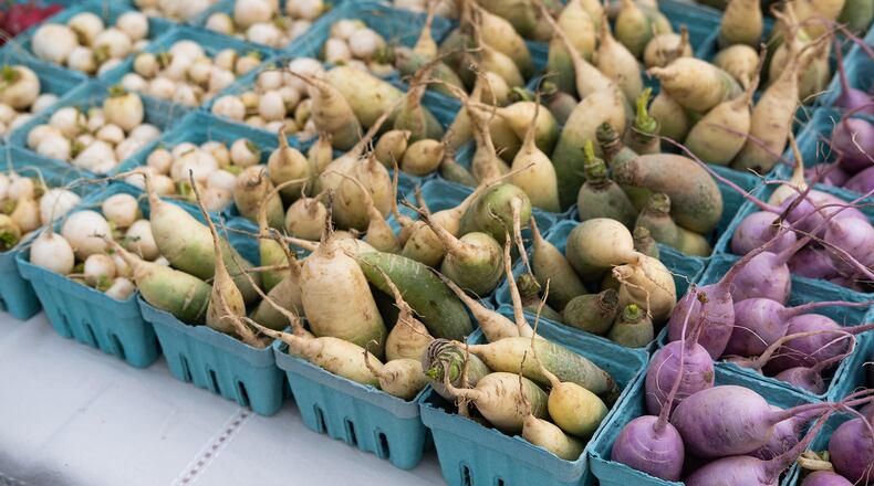 Purple and green daikon radishes sit next to hakurei turnips at Freedom Farmers Market.
Kris Martins for The Atlanta Journal-Constitution