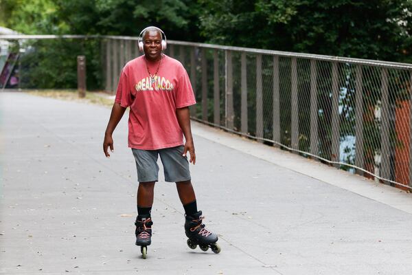 Kevin Randolph skates outside of Rreal Tacos on the Beltline across from Ponce City Market in Atlanta. He's skating on the Beltline almost every day. (Abbey Cutrer / AJC)