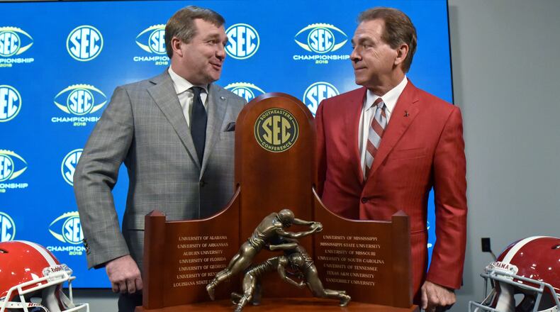 Georgia Head Coach Kirby Smart and Alabama Head Coach Nick Saba pose in front of the Championship Trophy during a SEC press conference at Mercedes-Benz Stadium on Friday, November 30, 2018. HYOSUB SHIN / HSHIN@AJC.COM