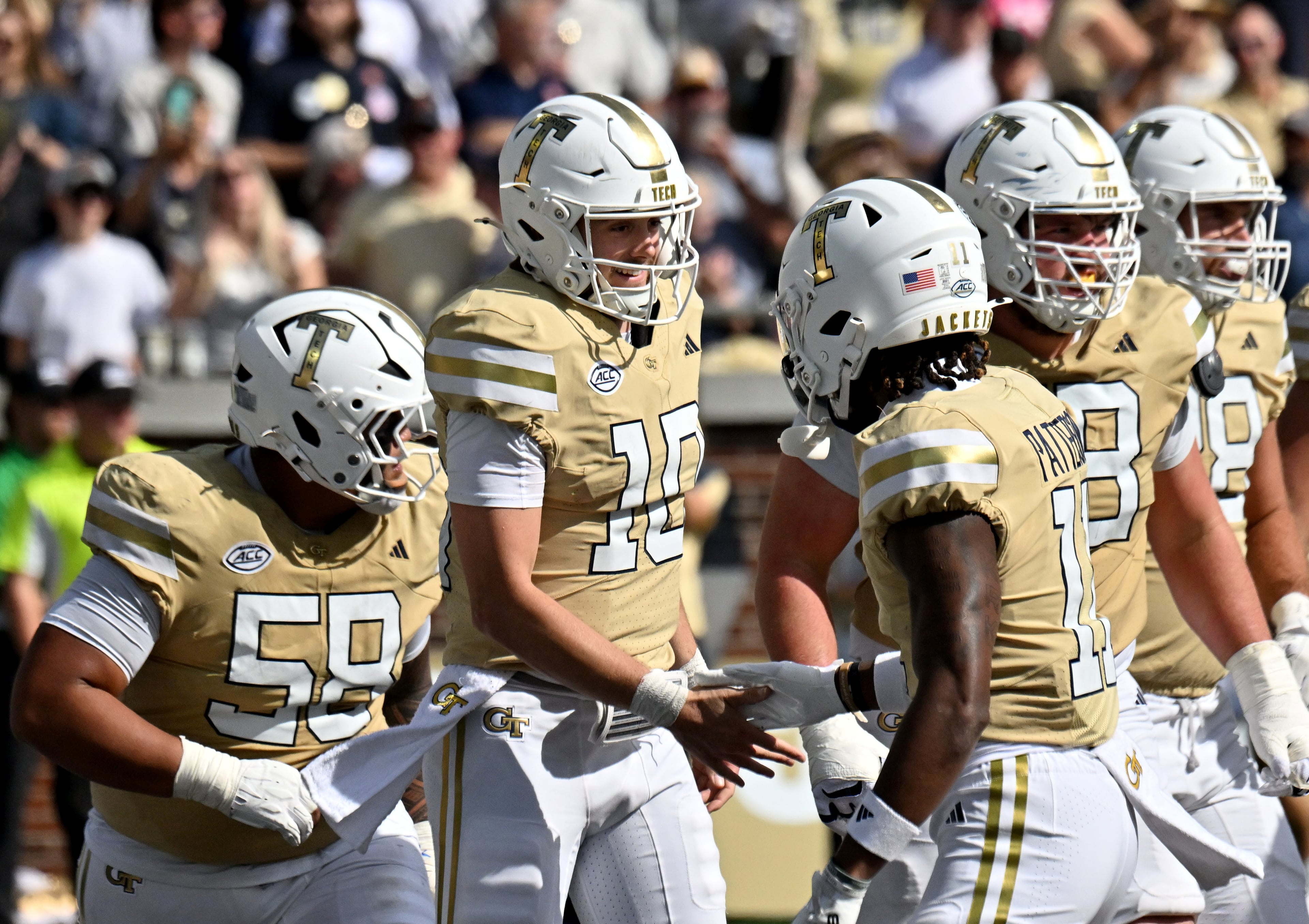 Georgia Tech quarterback Haynes King (second from left) celebrates with teammates after scoring a touchdown during the second half in an NCAA college football game at Bobby Dodd Stadium, Saturday, Oct. 25, 2025 in Atlanta. Georgia Tech won 41-16 over Syracuse. The Yellow Jackets are 8-0 for the first time since 1966 and 5-0 in the ACC for the first time ever. (Hyosub Shin/AJC)