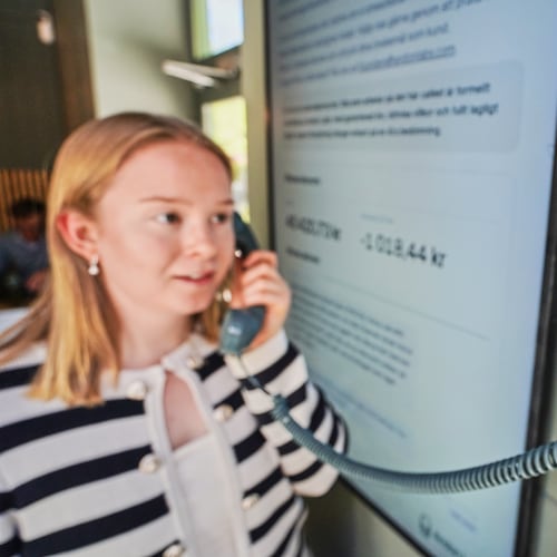 Hanna Petersson, a member of Andon Labs’ technical staff, uses a telephone handset to speak with Andon Café's AI agent 'Mona' in Stockholm, Sweden, Tuesday, May 5, 2026. (AP Photo/James Brooks)