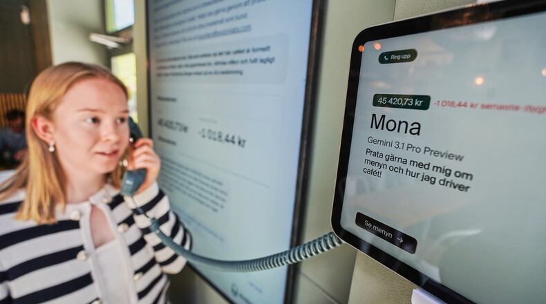 Hanna Petersson, a member of Andon Labs’ technical staff, uses a telephone handset to speak with Andon Café's AI agent 'Mona' in Stockholm, Sweden, Tuesday, May 5, 2026. (AP Photo/James Brooks)