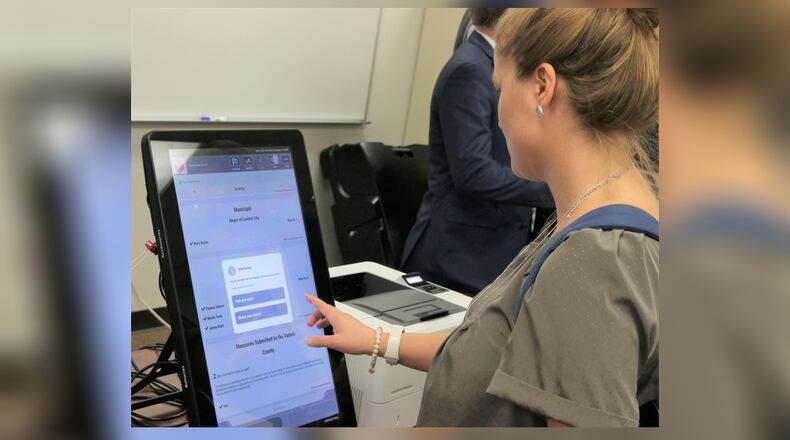 Georgia's new voting machines by Dominion Voting Systems were demonstrated at the Secretary of State's Office on Tuesday, Aug. 6, 2019. Voters will make their choices on touchscreens, which are connected to computers that will print out paper ballots for tabulation. Photo credit: Georgia Secretary of State