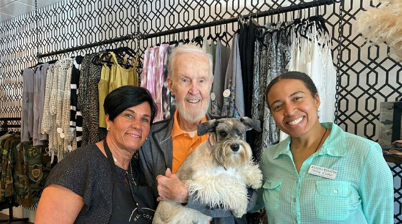A random act of kindness can be life changing. (L-R: Marlese Bogacki-Wilkes, owner of Mopp Design Studio and Luna, Ken Noren holding Luna and Mirna Coeur from Azalea Estates Assisted Living.
