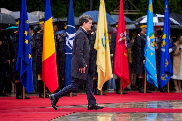 Romania's newly elected president Nicusor Dan reviews the honour guard during a welcoming ceremony at the Cotroceni Presidential Palace, after being sworn in at the parliament, in Bucharest, Romania, Monday, May 26, 2025. (AP Photo/Andreea Alexandru)