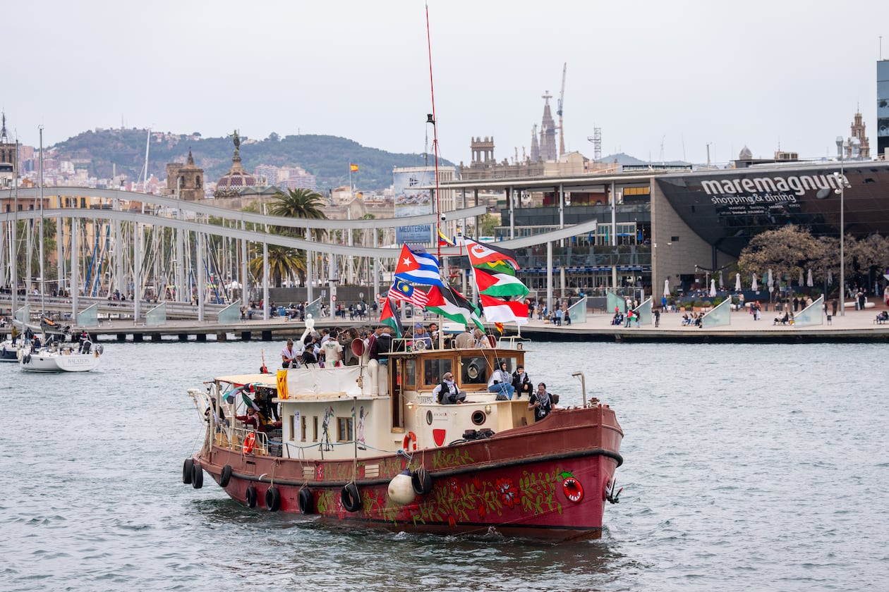 Boats carrying activists and humanitarian aid for Palestinians in Gaza reposition in the port during a symbolic send-off as part of the Global Sumud Flotilla, in Barcelona, Spain, Sunday, April 12, 2026. (AP Photo/Joan Mateu Parra)