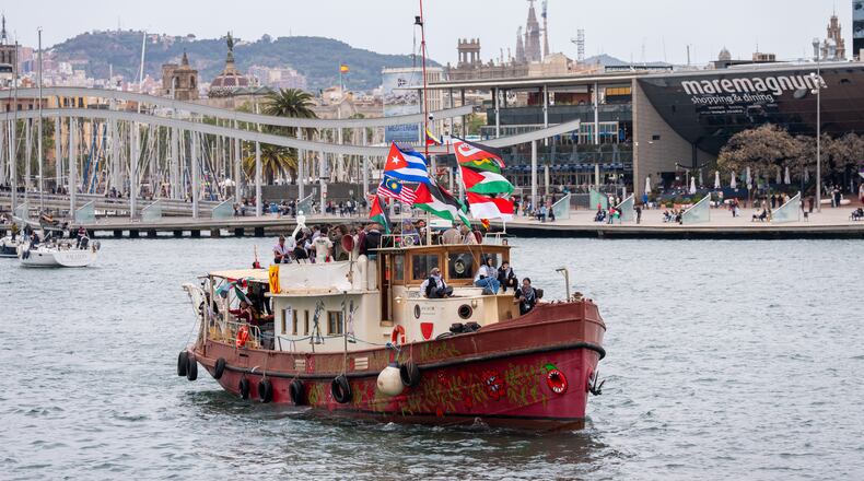 Boats carrying activists and humanitarian aid for Palestinians in Gaza reposition in the port during a symbolic send-off as part of the Global Sumud Flotilla, in Barcelona, Spain, Sunday, April 12, 2026. (AP Photo/Joan Mateu Parra)