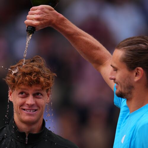 Alexander Zverev, of Germany, right, pours sparkling wine over the head of Jannik Sinner, of Italy, at the end of the men's singles tennis final match against at the Madrid Open tennis tournament in Madrid, Spain, Sunday, May 3, 2026. (AP Photo/Manu Fernandez)