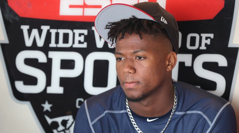 Braves outfielder Ronald Acuna, rated the consensus No. 1 prospect in baseball this winter by several experts, takes questions from the media during an interview in the dugout on Thursday, Feb 15, 2018, at Champion Stadium in Lake Buena Vista.  Curtis Compton/ccompton@ajc.com