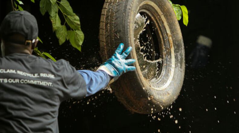 Laba Mbengue throws a tire full of water into his truck back in 2011. Mbengue, a long-time driver at Liberty Tire Recycling, helped organize the workers, who voted in October to join the Teamsters. On Friday, the workers unanimously approved the first contract negotiated with the company.