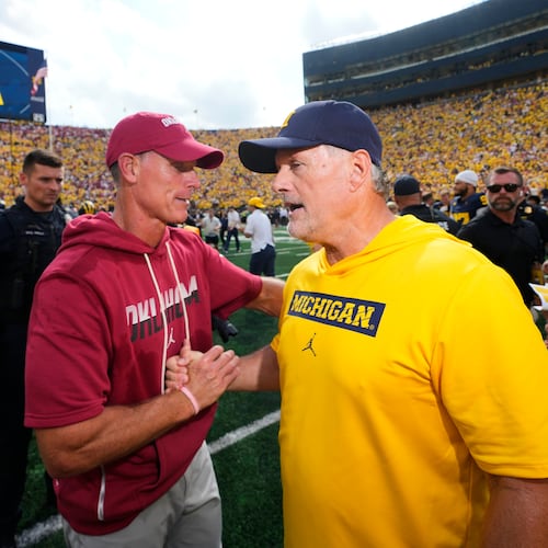 Oklahoma head coach Brent Venables, left, and Michigan head coach Kyle Whittingham, right, shake hands after an NCAA college football game Saturday, Sept. 12, 2026, in Ann Arbor, Mich. (AP Photo/Paul Sancya)