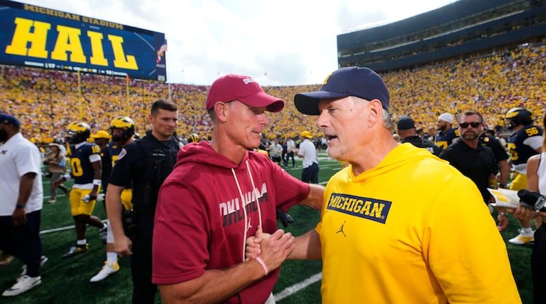 Oklahoma head coach Brent Venables, left, and Michigan head coach Kyle Whittingham, right, shake hands after an NCAA college football game Saturday, Sept. 12, 2026, in Ann Arbor, Mich. (AP Photo/Paul Sancya)