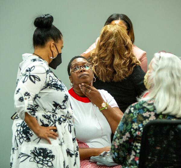 DeKalb County Elections Executive Director Keisha Smith (left) and Dele Lowman Smith (seated), chairwoman of the DeKalb County elections board, talk after hours of testing machines for a recount Saturday, May 28, 2022.  (Photo: Jenni Girtman for The Atlanta Journal-Constitution)