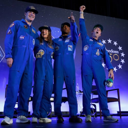 The Artemis II crew, from left, Jeremy Hansen, Christina Koch, Victor Glover and Reid Wiseman come to the center stage at the end of a crew return event Saturday, April 11, 2026, at Ellington Field in Houston. (AP Photo/Michael Wyke)