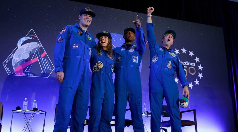 The Artemis II crew, from left, Jeremy Hansen, Christina Koch, Victor Glover and Reid Wiseman come to the center stage at the end of a crew return event Saturday, April 11, 2026, at Ellington Field in Houston. (AP Photo/Michael Wyke)