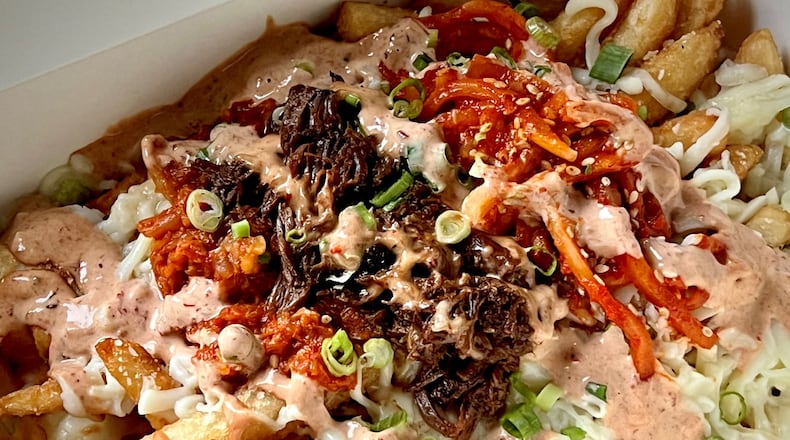 Salaryman's kalbi jjim poutine tops the classic Canadian dish with a flavorful Korean short rib stew. Henri Hollis/henri.hollis@ajc.com