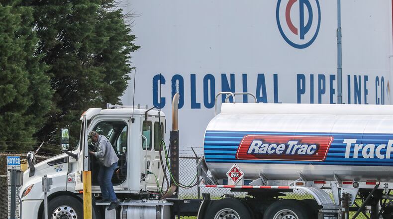 Gasoline tankers pass by the Colonial Pipeline storage tanks in Austell earlier this year. Alpharetta-based Colonial Pipeline delivers roughly 45% of the fuel consumed on the East Coast. (John Spink/The Atlanta Journal-Constitution/TNS)