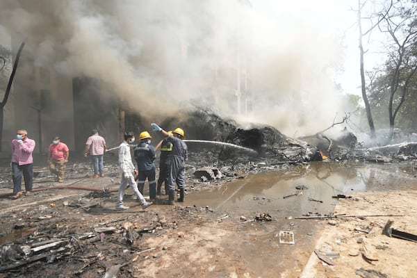 Firefighters work at the site of an airplane that crashed in India's northwestern city of Ahmedabad in Gujarat state, Thursday, June 12, 2025. (AP Photo/Ajit Solanki)