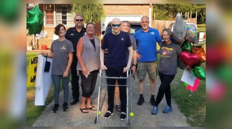 Model High School student Logan Knight, surrounded by family and friends, returned home to a surprise car parade after months of cancer treatments at Scottish Rite Hospital in Atlanta. (Family Handout)