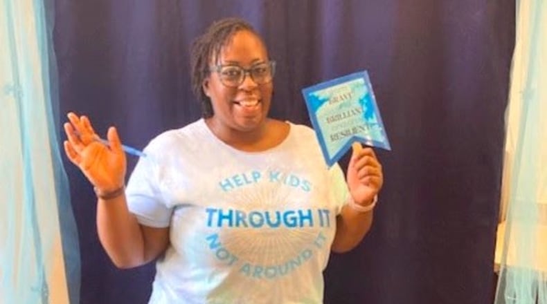 Working with local librarians, like Erica in this photo, Strong4Life has curated a list of books which have themes related to resilience and then developed a list of reflection questions so caregivers and children can talk about these issues together. COURTESY CHILDREN'S HEALTHCARE OF ATLANTA STRONG4LIFE