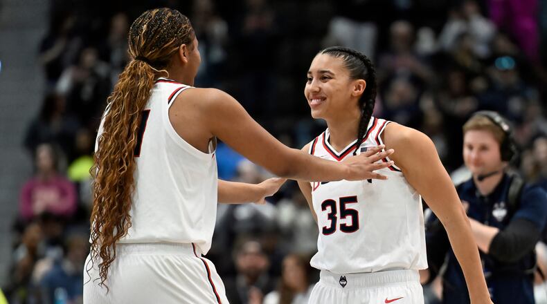 UConn forward Sarah Strong, left, talks with UConn guard Azzi Fudd, right, before tip off in an NCAA college basketball game against Georgetown, Thursday, Feb. 26, 2026, in Hartford, Conn. (AP Photo/Jessica Hill)