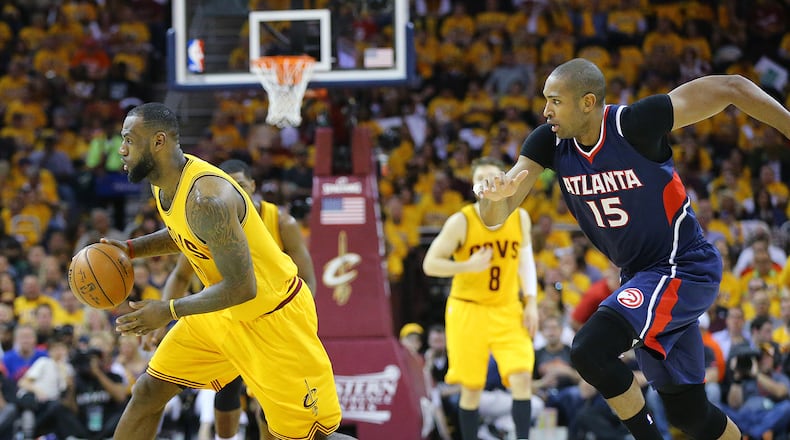 Cavaliers LeBron James steals from the Hawks with Al Horford in pursuit in the Eastern Conference Finals on Sunday, May 24, 2015, in Cleveland. Curtis Compton / ccompton@ajc.com