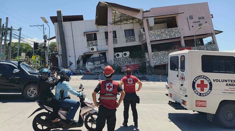 In this photo provided by the Philippine Red Cross, rescuers inspect the damage after an earthquake in General Santos, Philippines, Monday, June 8, 2026. (Philippine Red Cross via AP)