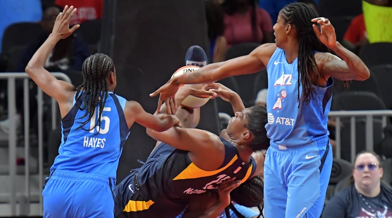 Indiana Fever center Teaira McCowan (15) falls onto Atlanta Dream center Elizabeth Williams (1) as they fight for a rebound during the second half of WNBA basketball game at State Farm Arena in Atlanta on Wednesday, June 19, 2019. Atlanta Dream won 88-78 over the Indiana Fever. HYOSUB SHIN / HSHIN@AJC.COM