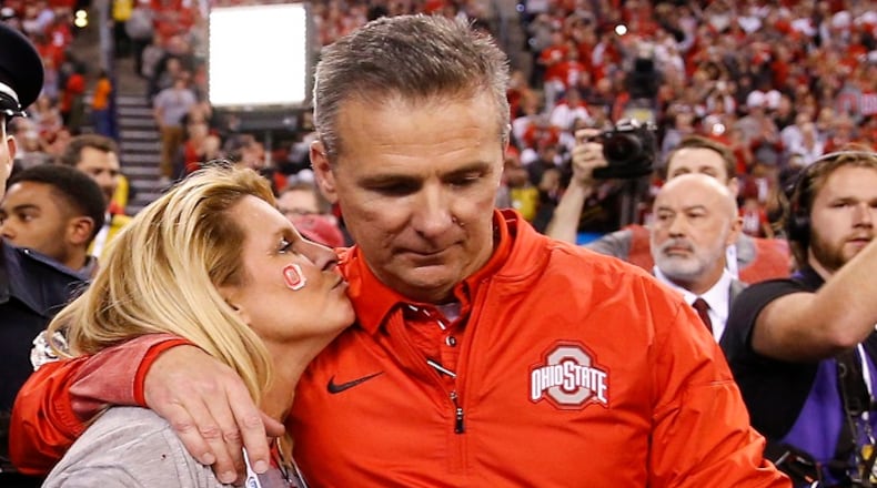 Ohio State Buckeyes head coach Urban Meyer gets a kiss after his team's 27-21 Big Ten Champsionship win over the Wisconsin Badgers at Lucas Oil Stadium Sunday, Dec. 3, 2017 in Indianapolis. (Sam Riche/TNS)