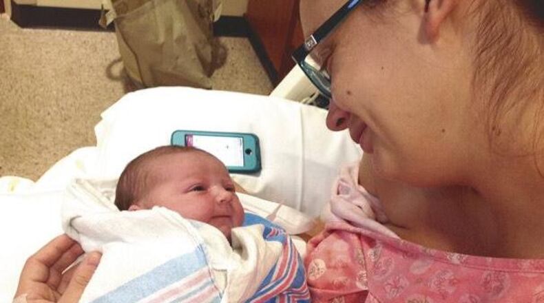 Charleston, S.C., resident Anne Funderburk holds her daughter, who was born in Peachtree City after the family evacuated due to Hurricane Matthew. (Credit: The Funderburk family)