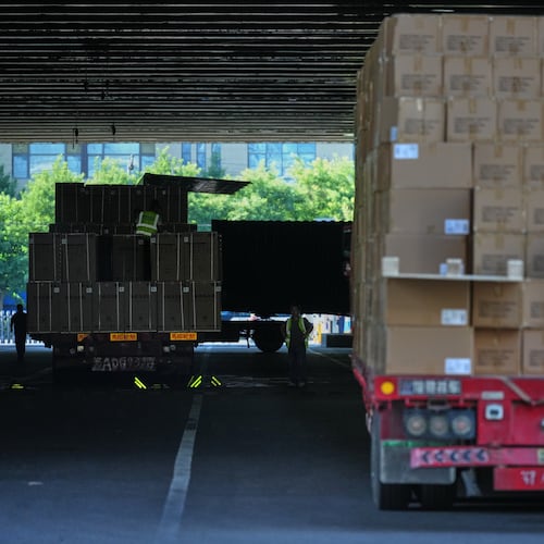 Workers transfer goods from a truck at the Xiaomi logistic center, in Beijing, China on Friday, May 29, 2026. (AP Photo/Andy Wong)