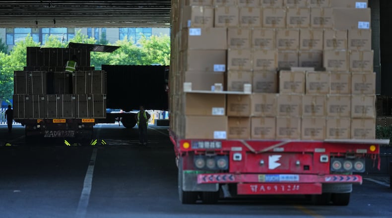 Workers transfer goods from a truck at the Xiaomi logistic center, in Beijing, China on Friday, May 29, 2026. (AP Photo/Andy Wong)