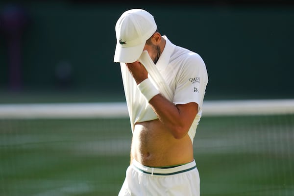 Novak Djorkovic of Serbia reacts during the men's semifinal singles match against Jannik Sinner of Italy at the Wimbledon Tennis Championships in London, Friday, July 11, 2025.(AP Photo/Kirsty Wigglesworth)