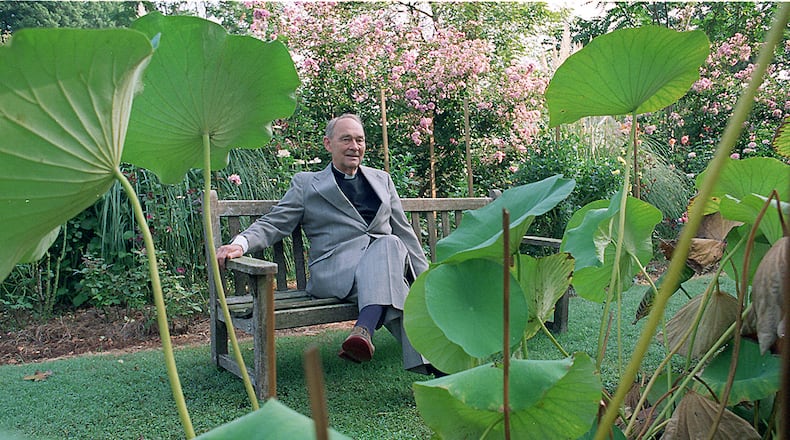 Father Austin Ford, sits outside surrounded by Lotus garden with his Roses located in the background of his Emmaus House. (Eric Williams / AJC File)