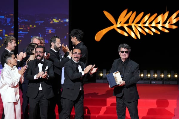 Director Jafar Panahi, right, accepts the Palme d'Or for the film 'It Was Just an Accident', during the awards ceremony of the 78th international film festival, Cannes, southern France, Saturday, May 24, 2025. (Photo by Lewis Joly/Invision/AP)