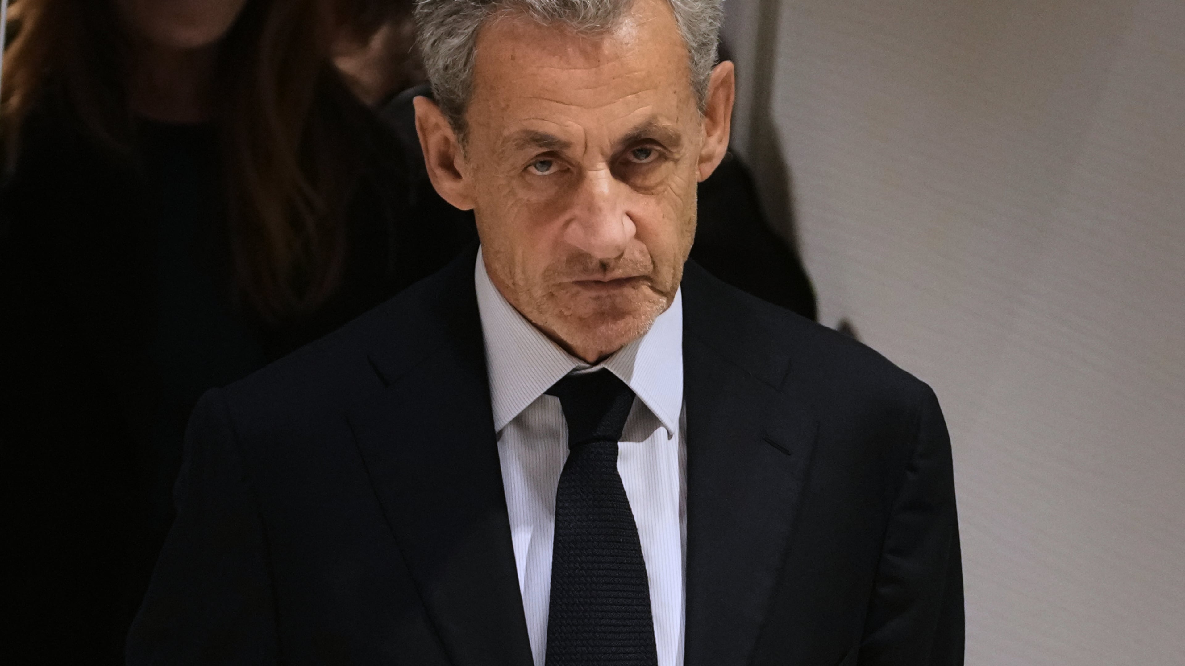 FILE- Former French President Nicolas Sarkozy leaves after a Paris court sentenced him to 5 years after finding him guilty of criminal conspiracy in an alleged scheme to finance his 2007 campaign with funds from Libya, Thursday, Sept. 25, 2025 in Paris. (AP Photo/Christophe Ena, File)