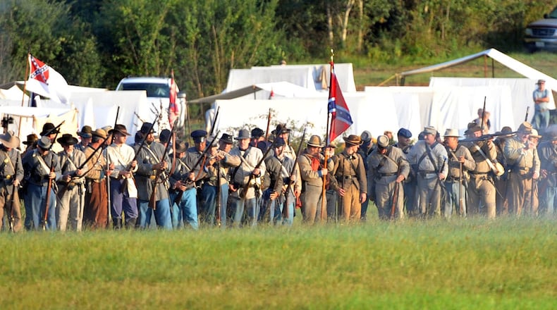 Confederate and Union re-enactors recreate the Battle of Utoy Creek during the Atlanta Campaign’s Battle of Atlanta re-enactment at the Nash Farm Battlefield in Hampton, Ga., on Sept. 19, 2014. KENT D. JOHNSON / KDJOHNSON@AJC.COM