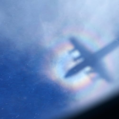 FILE -The shadow of a Royal New Zealand Air Force P3 Orion is seen on low level cloud while the aircraft searches for missing Malaysia Airlines Flight MH370 in the southern Indian Ocean, near the coast of Western Australia, March 31, 2014. (AP Photo/Rob Griffith, File)
