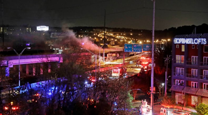 Smoke billows from a section of an overpass that collapsed from a large fire on Interstate 85 in Atlanta, Thursday, March 30, 2017. Witnesses say troopers were telling cars to turn around on the bridge because they were concerned about its integrity. Minutes later, the bridge collapsed. (AP Photo/David Goldman)