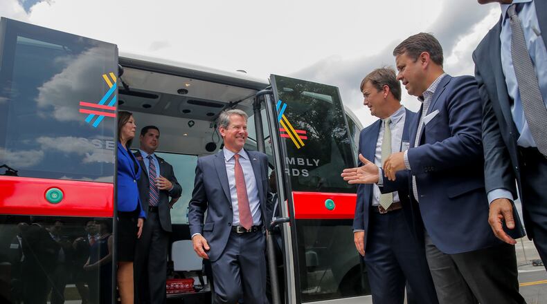 Gov. Brian Kemp disembarks from a ride on a driver-less shuttle in Doraville. Alyssa Pointer/AJC