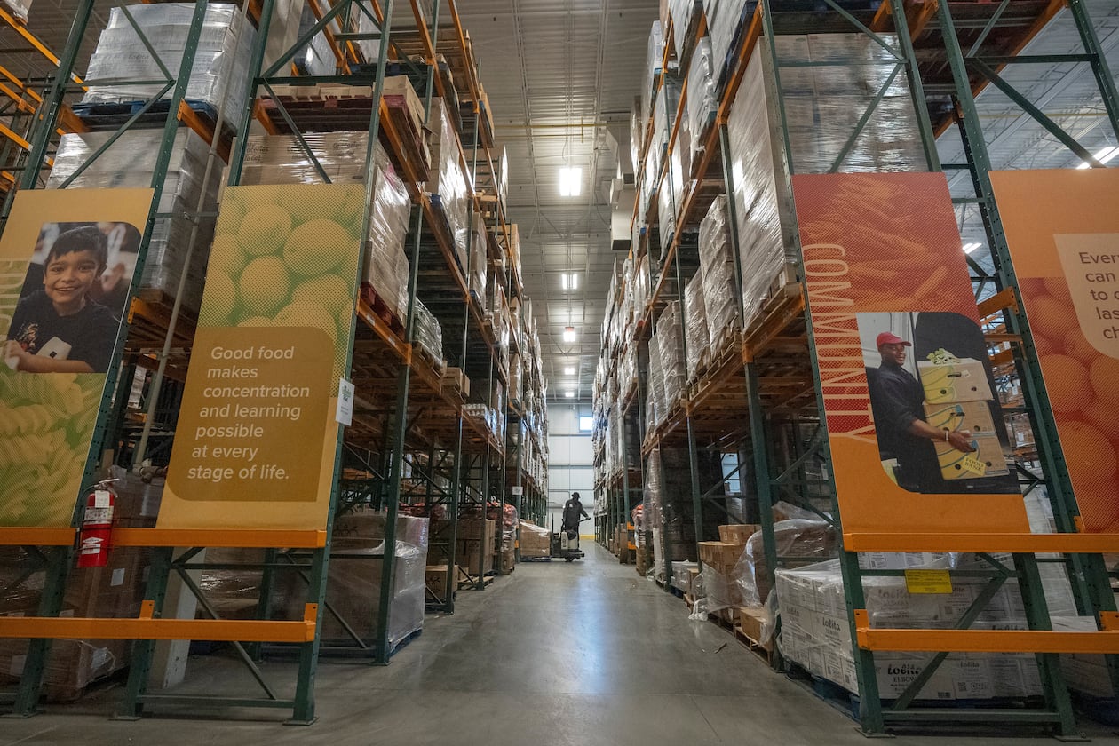 An employee moves pallets of food at a warehouse of the Capital Area Food Bank, Thursday, Nov. 6, 2025, in Washington. (AP Photo/Mark Schiefelbein)