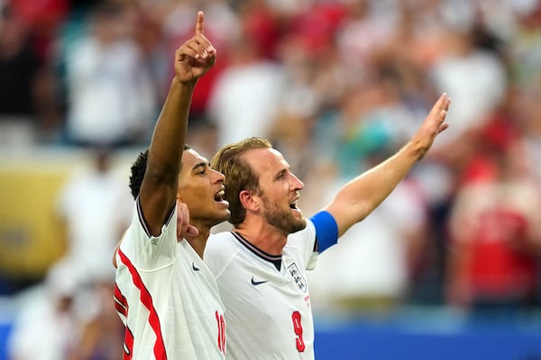 England stars Jude Bellingham (left) and Harry Kane celebrate their quarterfinal win over Norway. (Julio Cortez/AP)
