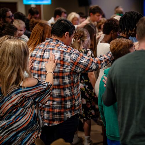Jamie Cachua, in flannel, prays with his wife and fellow congregants at their church in Rome, north of Atlanta.. Cachua left Mexico in a car seat bound for the U.S. when he was 10 months old. Today, the family man lives amid people who voted for President Donald Trump. (Erin Schaff/The New York Times)