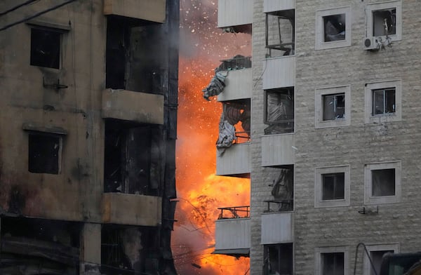 Flames rise between two buildings after an Israeli airstrike on Dahiyeh in the southern suburb of Beirut, Lebanon, Sunday, April 27, 2025. (AP Photo/Hussein Malla)