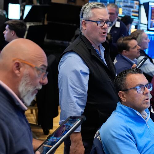 People work on the floor at the New York Stock Exchange in New York, Monday, March 30, 2026. (AP Photo/Seth Wenig)